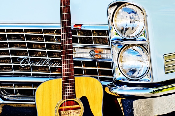 Vintage car front with a guitar