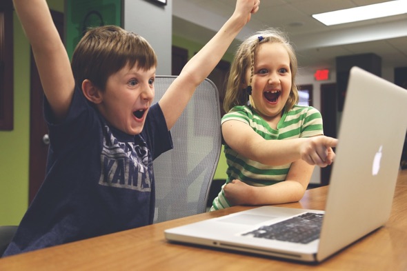 Children happy with a MacBook